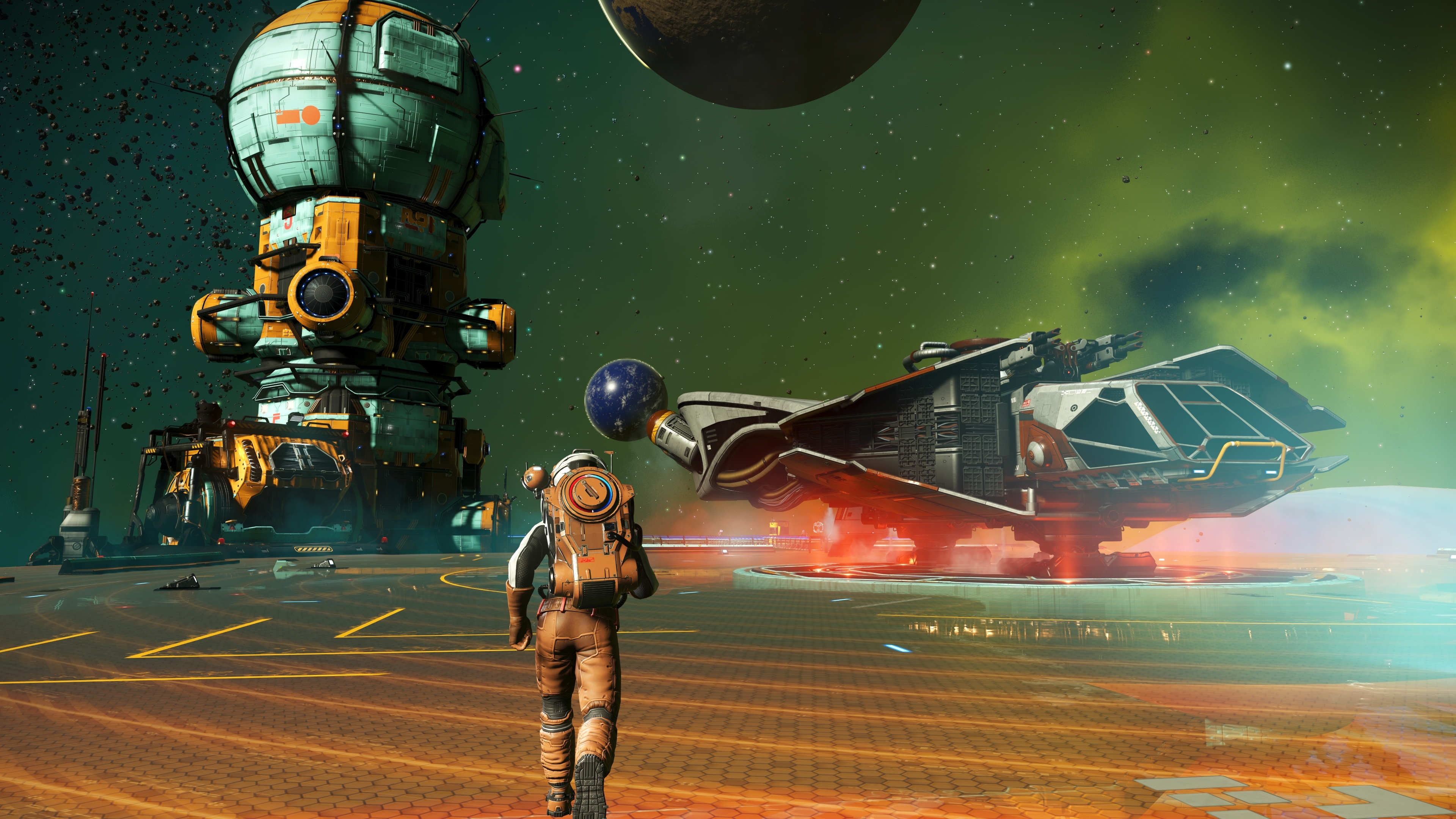 An astronaut in a tan exosuit walks across an orange hexagonal landing deck toward a docked starship at a No Man's Sky deep-space outpost, a brown planet and green nebula overhead.